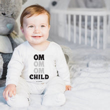 Load image into Gallery viewer, This super soft OM Child short sleeve one-piece for your tiny warrior features 100% combed and ring-spun cotton, and our classic "OM OM OM CHILD" front graphic printed with eco-friendly inks. The onesie design has has a three snap leg closure for easy changing at the bottom and a envelope neckline for ultimate comfort.