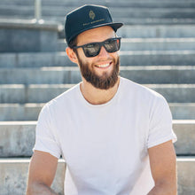 Load image into Gallery viewer, A classic staple. This mesh back snapback hat features a casual and comfortable fit with our OM Warrior logo design and adjustable strap for an every-season essential.