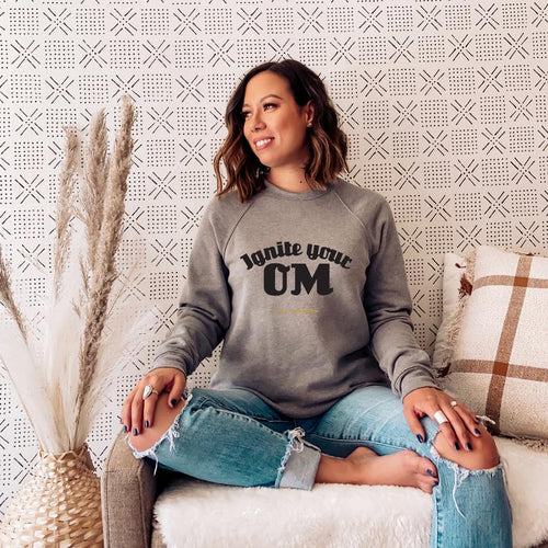 Radiate good energy in our Ignite Your OM Classic Crew Sweatshirt, featuring a rib crewneck, raglan sleeves, and 'Ignite Your OM' front graphic printed with eco-friendly inks. Relaxed, slightly oversized fit. Made with 50% cotton and 50% polyester for ultimate coziness.